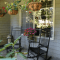 Oak black front porch rocking chairs with hanging flower pot