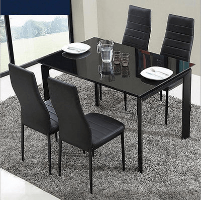 Black dining room table and chair sets with glass centrepieces