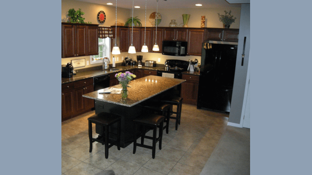 Brown Kitchen island with overhang granite countertop and nice decoration