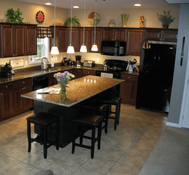 Brown Kitchen island with overhang granite countertop and nice decoration